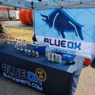 Blue Ox booth with sign, table cloth and products