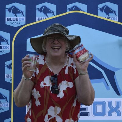 Ox fans holding inflatables in front of the Blue Ox logo backdrop