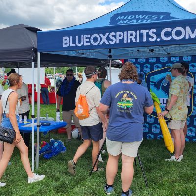 A group of people in front of the Blue Ox booth